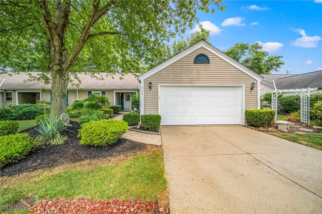 View of front of house featuring driveway and an attached garage