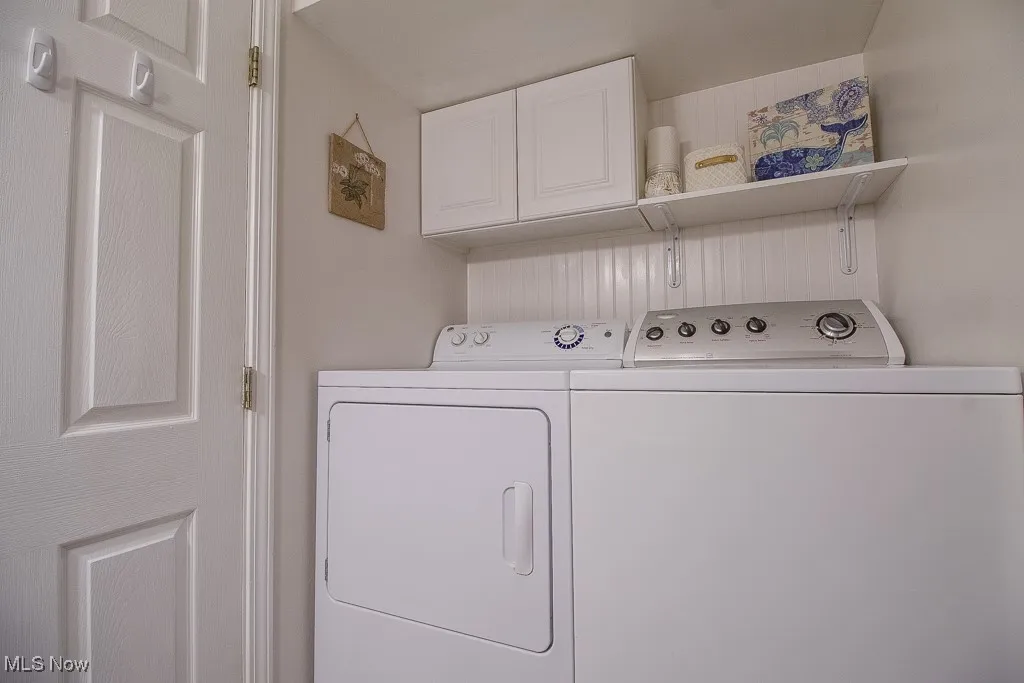Laundry area with separate washer and dryer and cabinet space