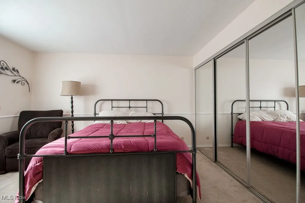 Bedroom featuring carpet and a closet