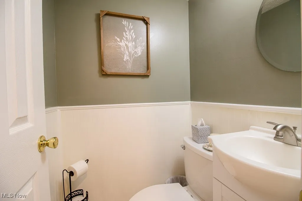 Bathroom featuring vanity and a wainscoted wall