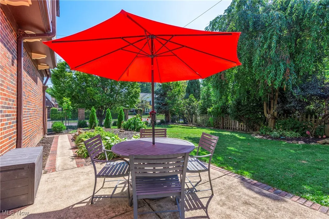 Fenced backyard featuring outdoor dining space and a patio area