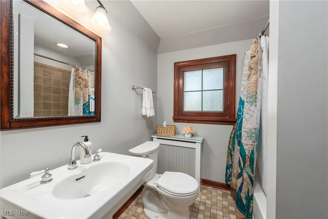 Full bathroom featuring toilet and shower / bath combo