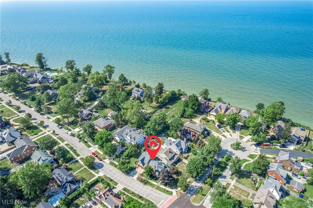 Aerial view of property's location featuring nearby suburban area and a large body of water