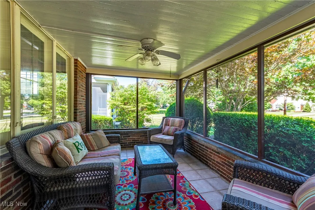 Sunroom / solarium featuring a ceiling fan and outdoor lounge area