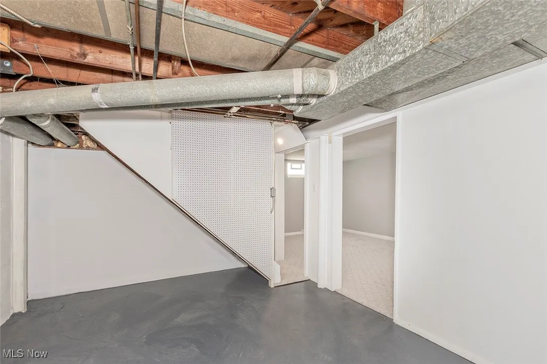Unfinished basement with baseboards