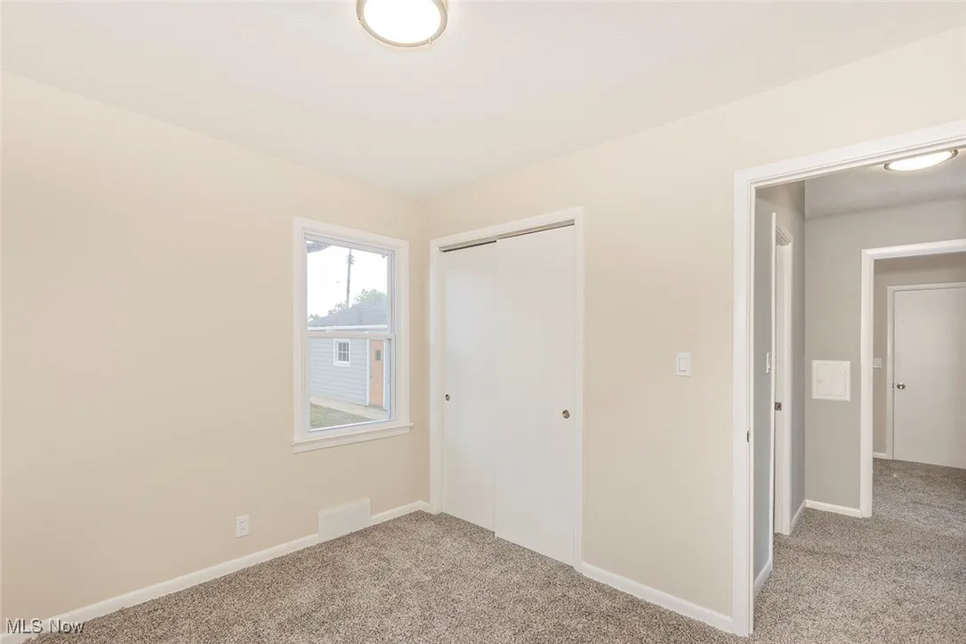 Unfurnished bedroom featuring carpet floors and a closet