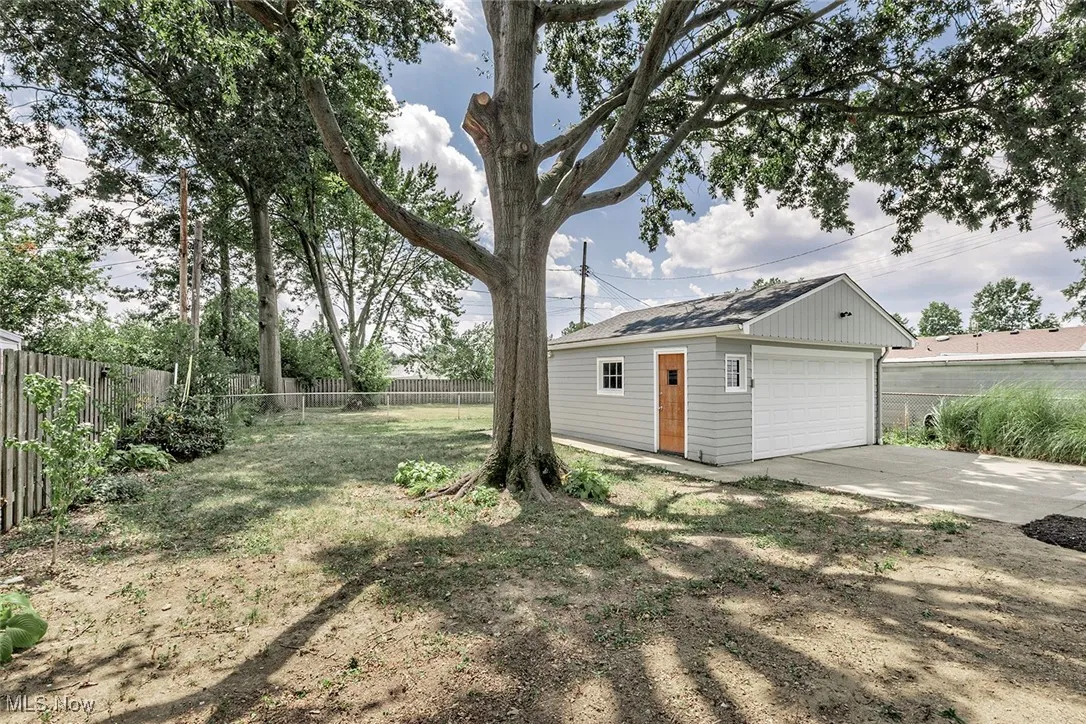 View of yard with an outdoor structure and a garage