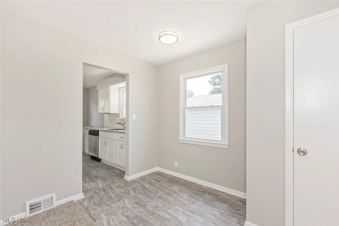Spare room featuring baseboards