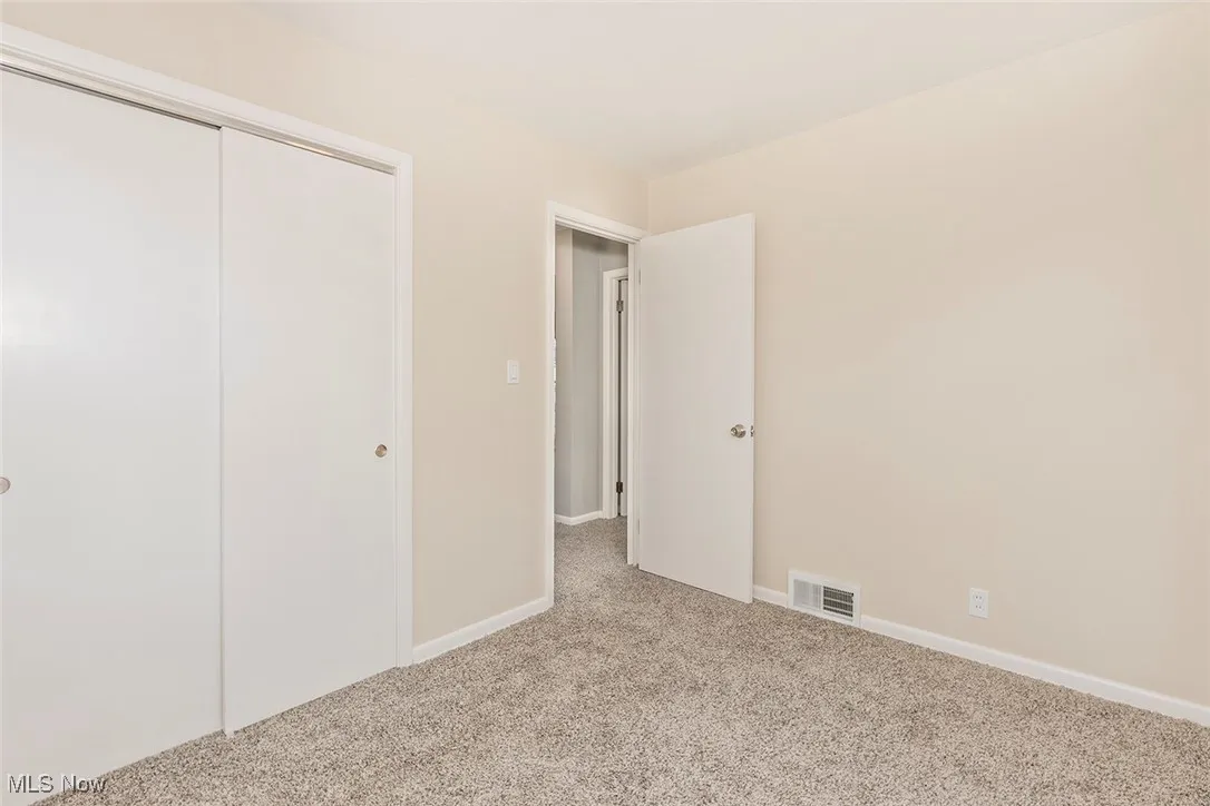 Unfurnished bedroom with a closet and carpet flooring