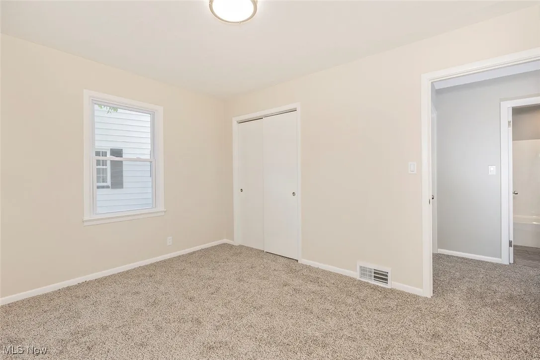 Unfurnished bedroom featuring carpet floors and a closet