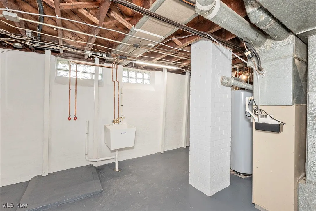 Basement featuring gas water heater and heating unit