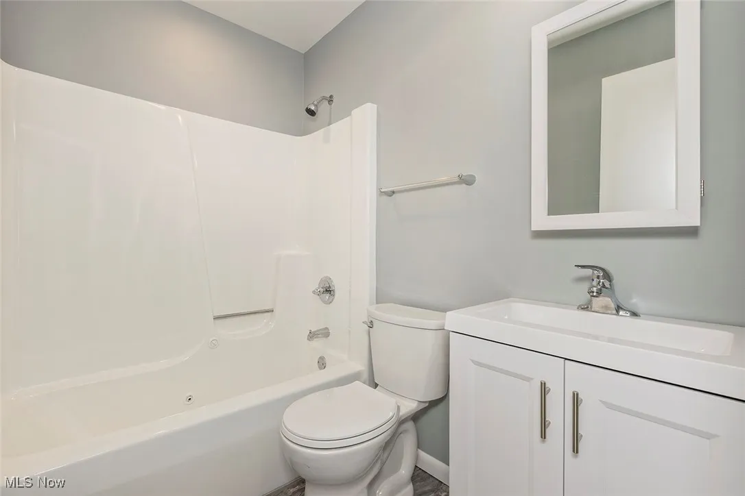 Full bathroom with shower / tub combination and vanity