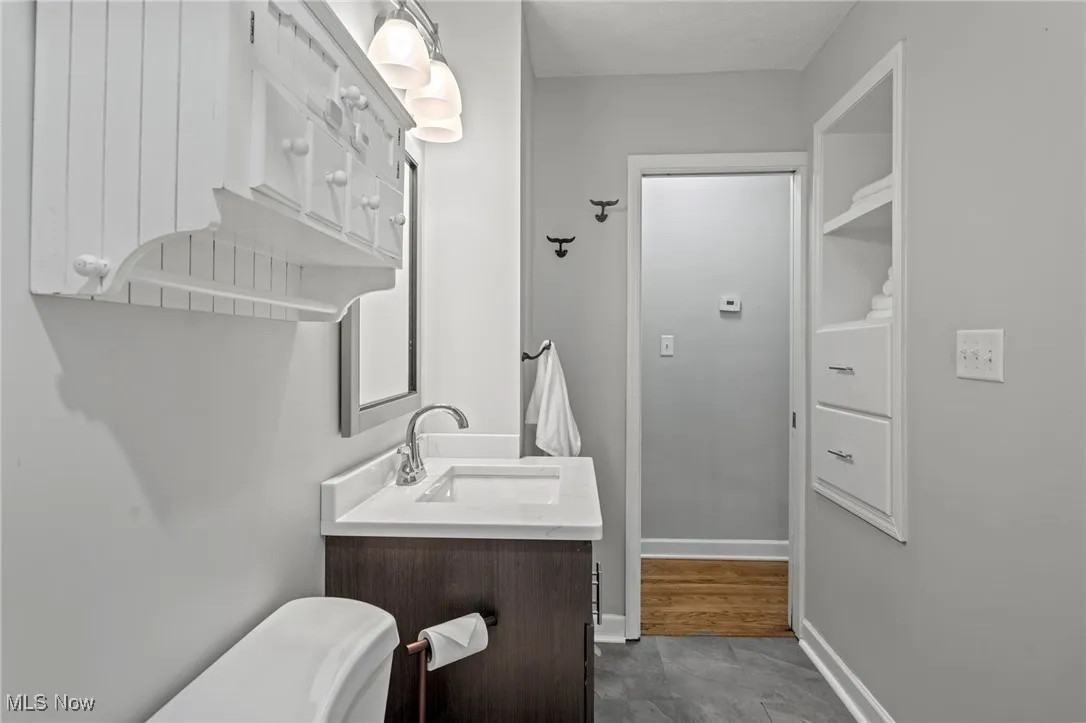 Bathroom featuring vanity and baseboards