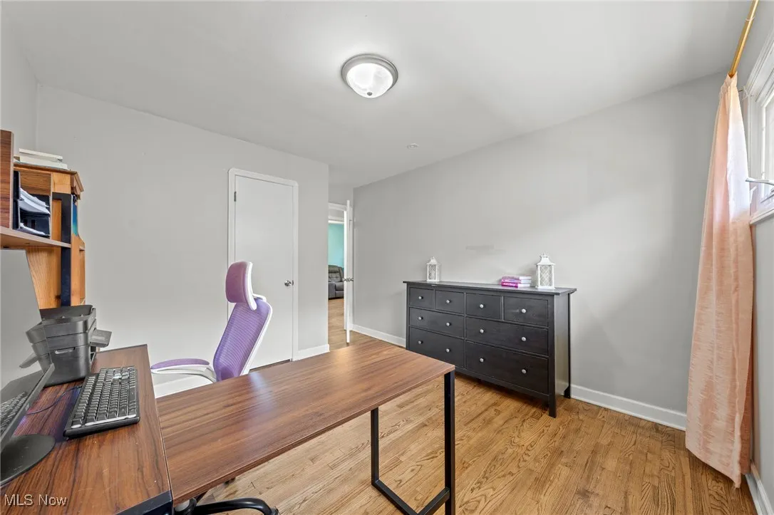 Office space featuring light wood finished floors and baseboards