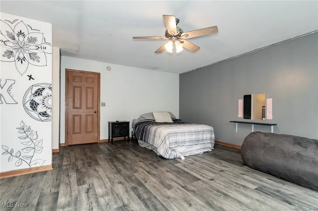 Bedroom featuring wood finished floors and ceiling fan