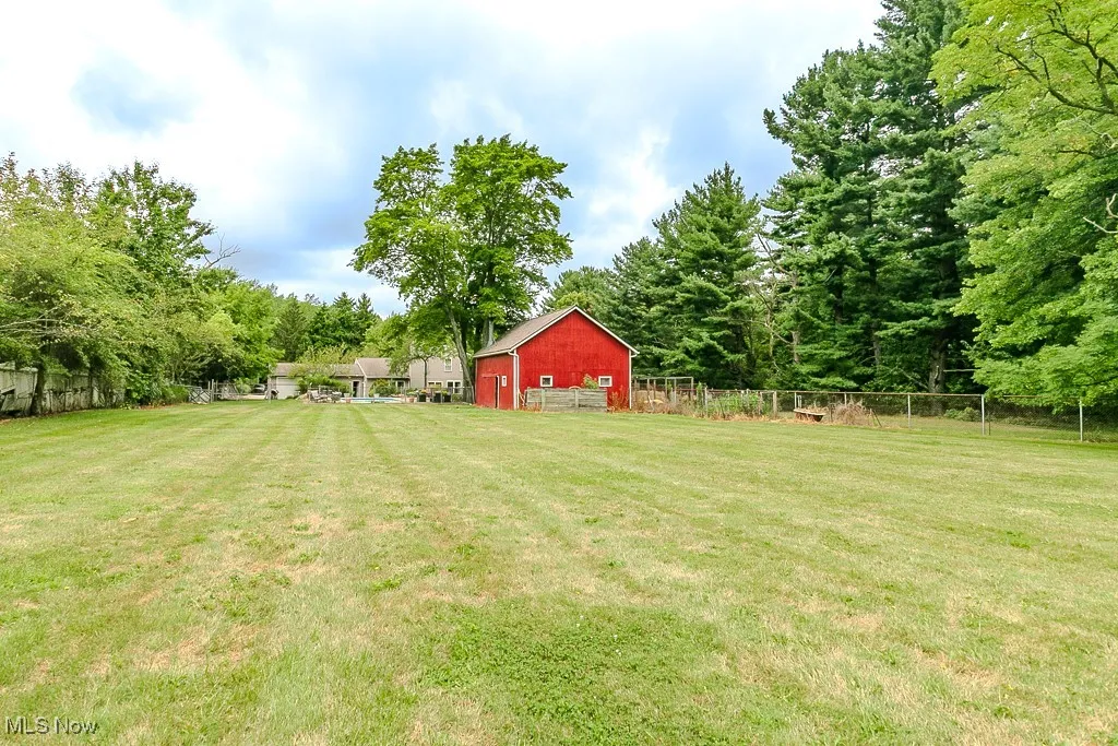 View of yard featuring an outbuilding and a barn