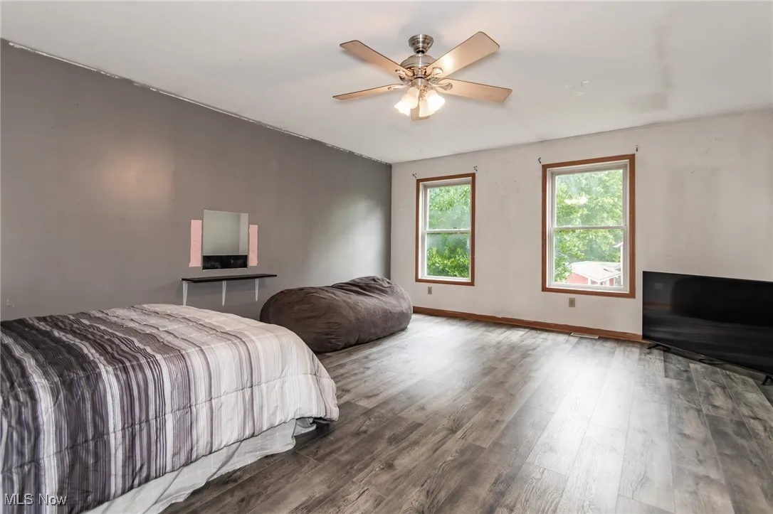 Bedroom with wood finished floors and ceiling fan