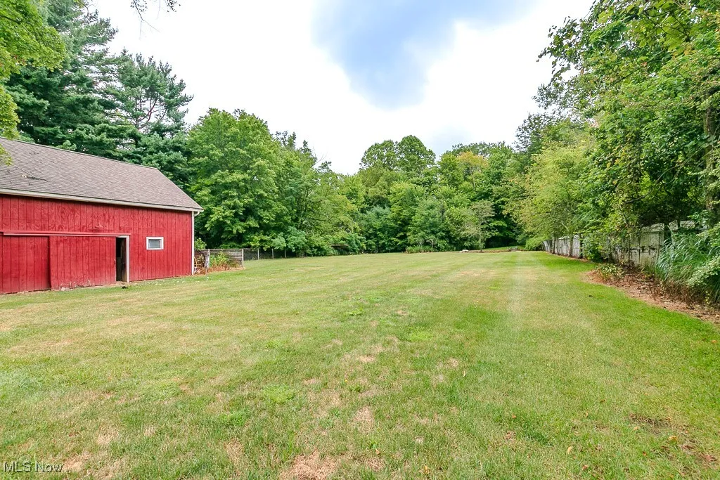 View of yard featuring an outbuilding and a barn