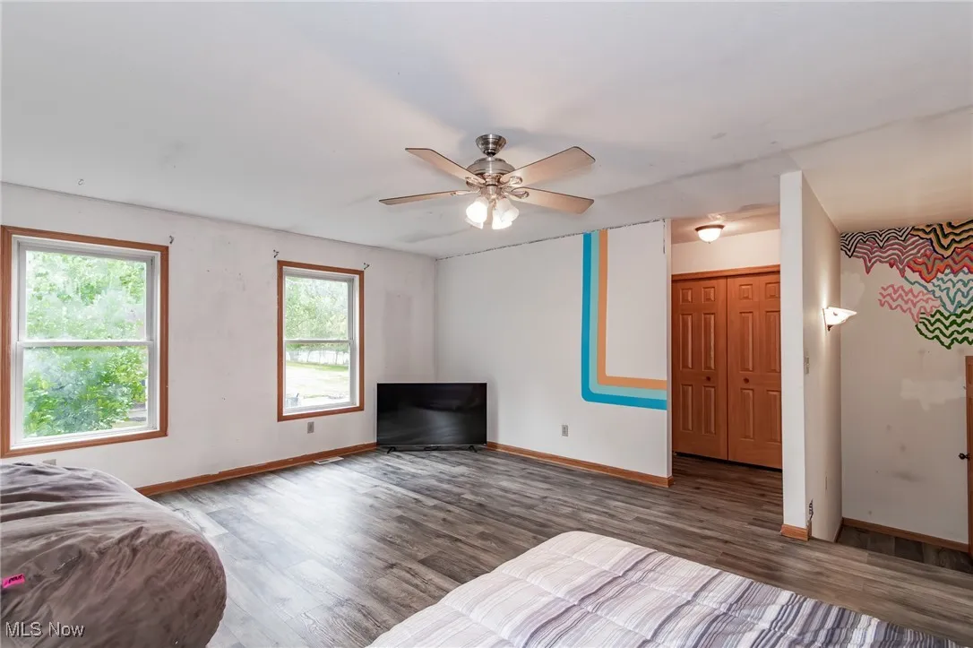 Bedroom featuring wood finished floors and ceiling fan
