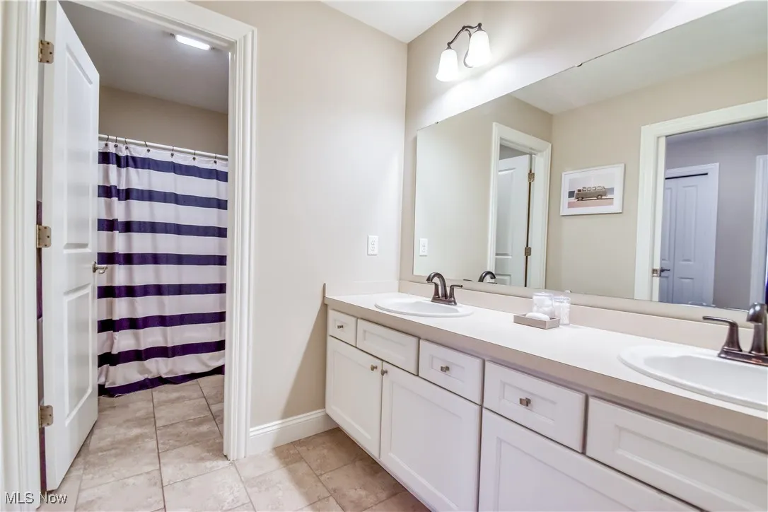 2nd floor hall bath with double vanity and private shower/toilet space
