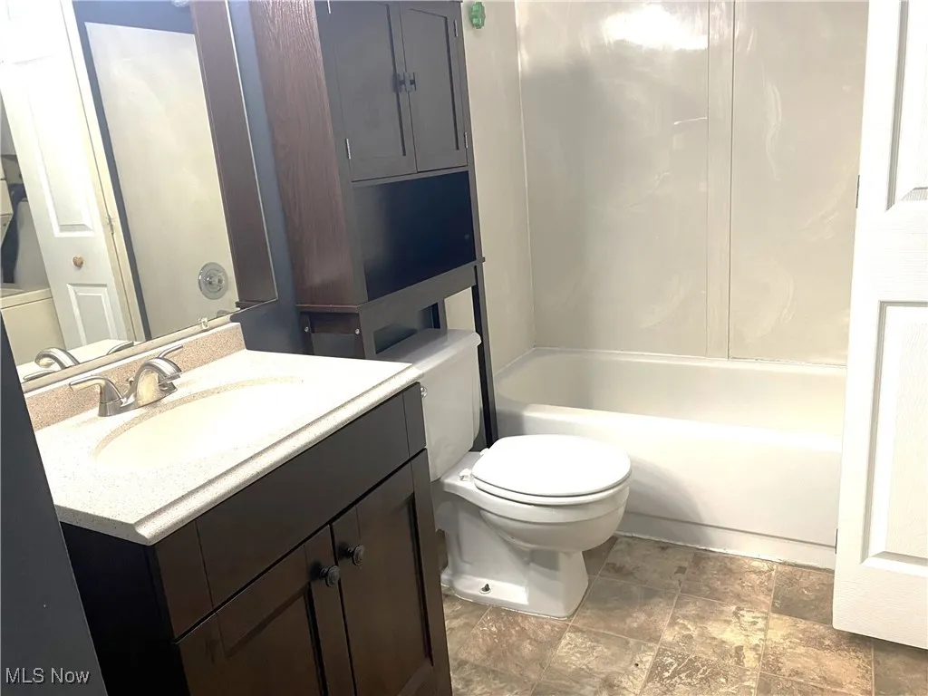 Guest bath with tub/shower-sink and toilet.  Stack washer-dryer in closet