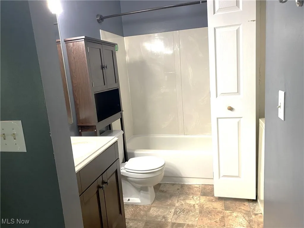Guest bath with tub/shower-sink and toilet.  Stack washer-dryer in closet