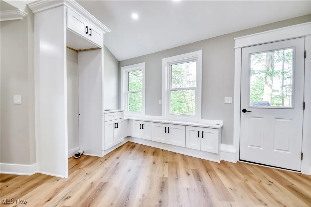 Entryway featuring wood finished floors, lofted ceiling, and recessed lighting