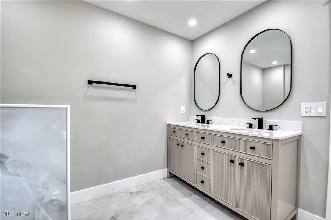 Full bathroom with double vanity and recessed lighting