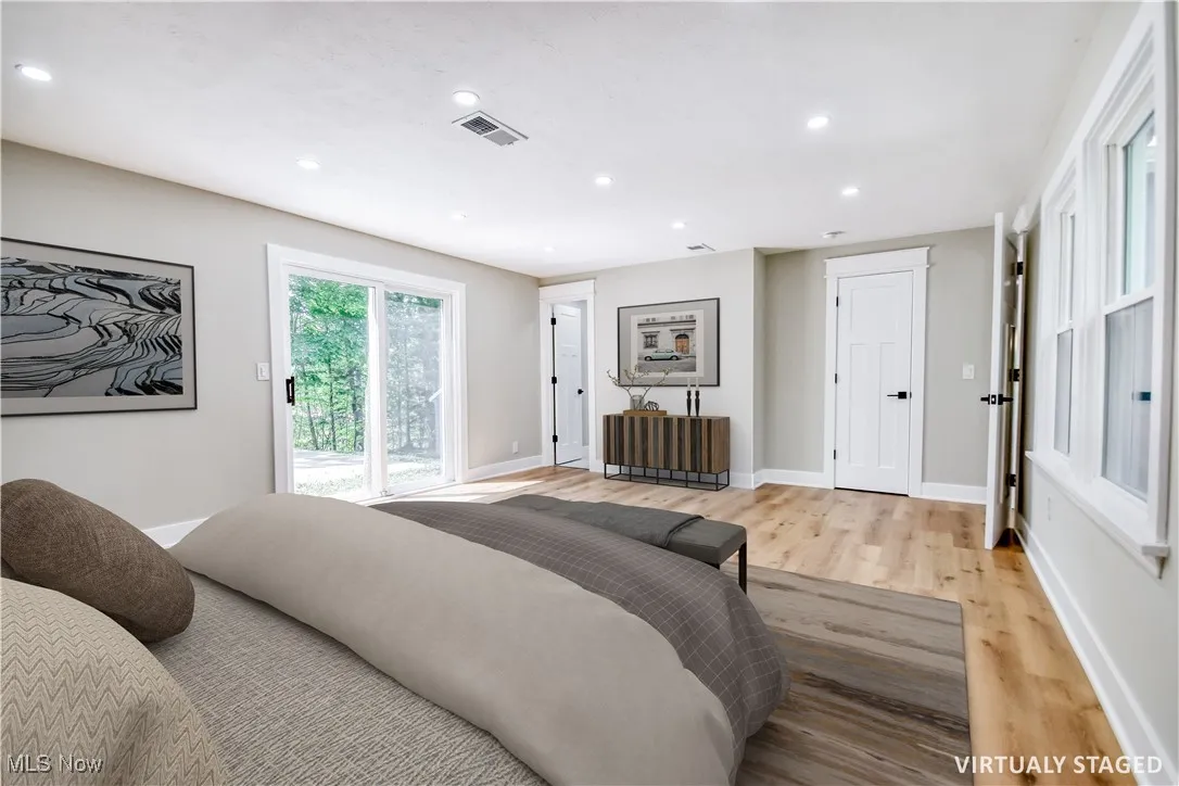 Bedroom featuring recessed lighting, wood finished floors, and access to exterior