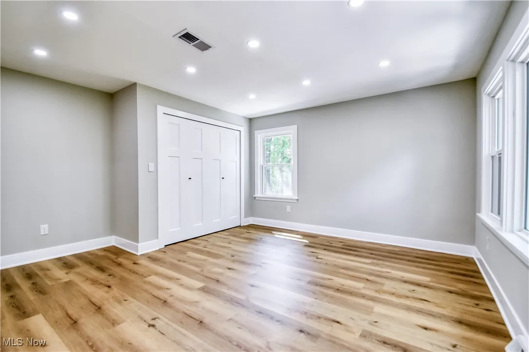 Unfurnished bedroom with recessed lighting, a closet, and light wood-style floors
