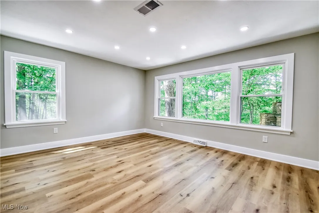 Unfurnished room with plenty of natural light, recessed lighting, and light wood-type flooring
