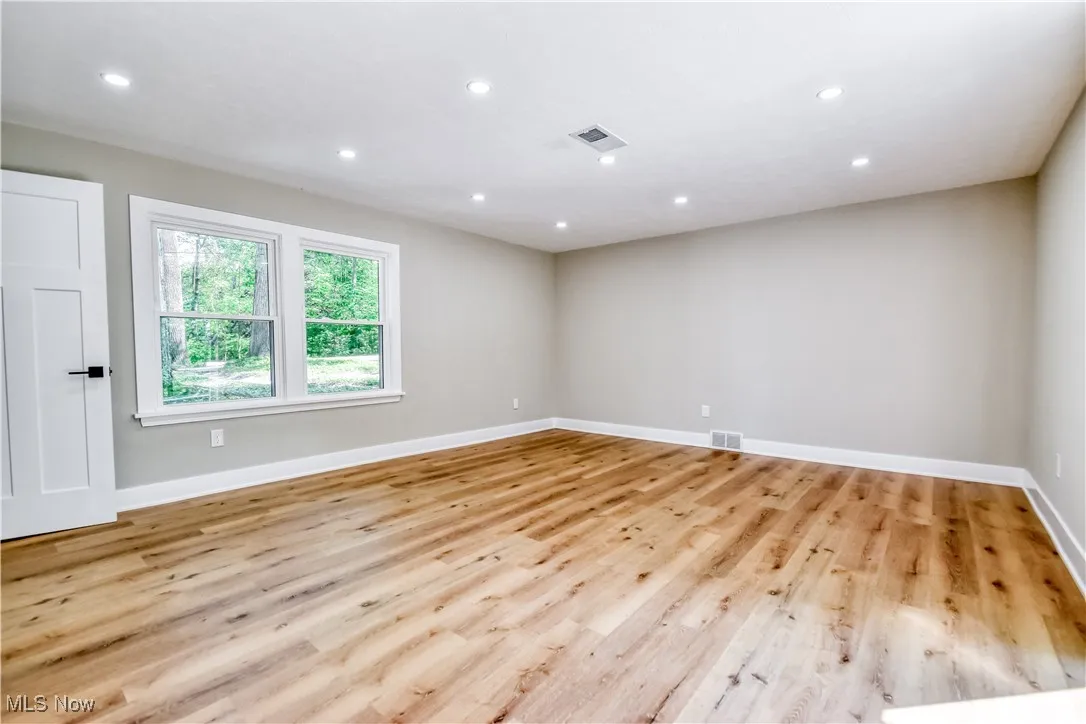 Empty room with recessed lighting and light wood-type flooring