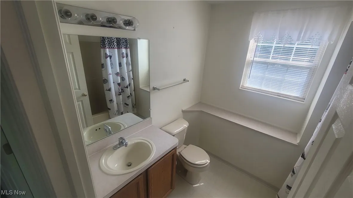 Full bathroom with vanity and shower / bathtub combination with curtain
