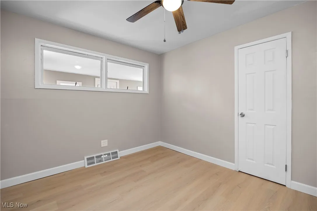 Spare room with light wood-style flooring and a ceiling fan
