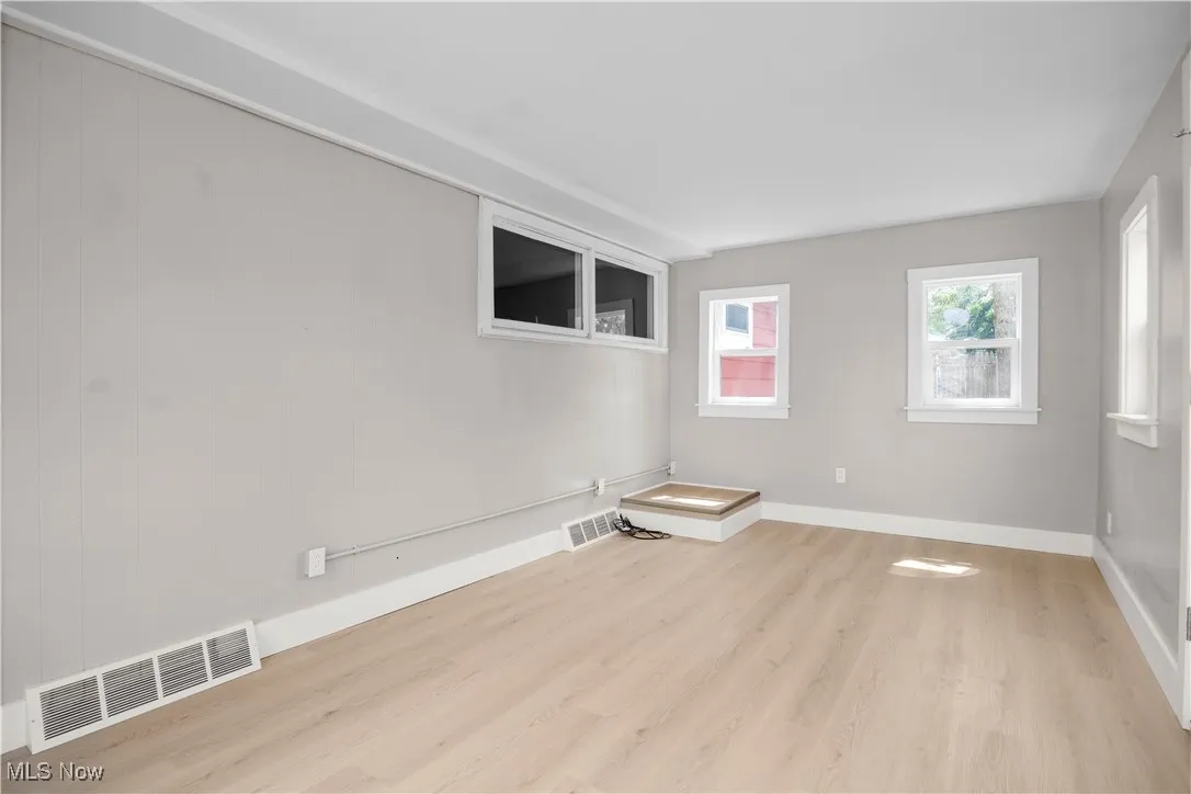 Unfurnished room featuring light wood-type flooring and baseboards