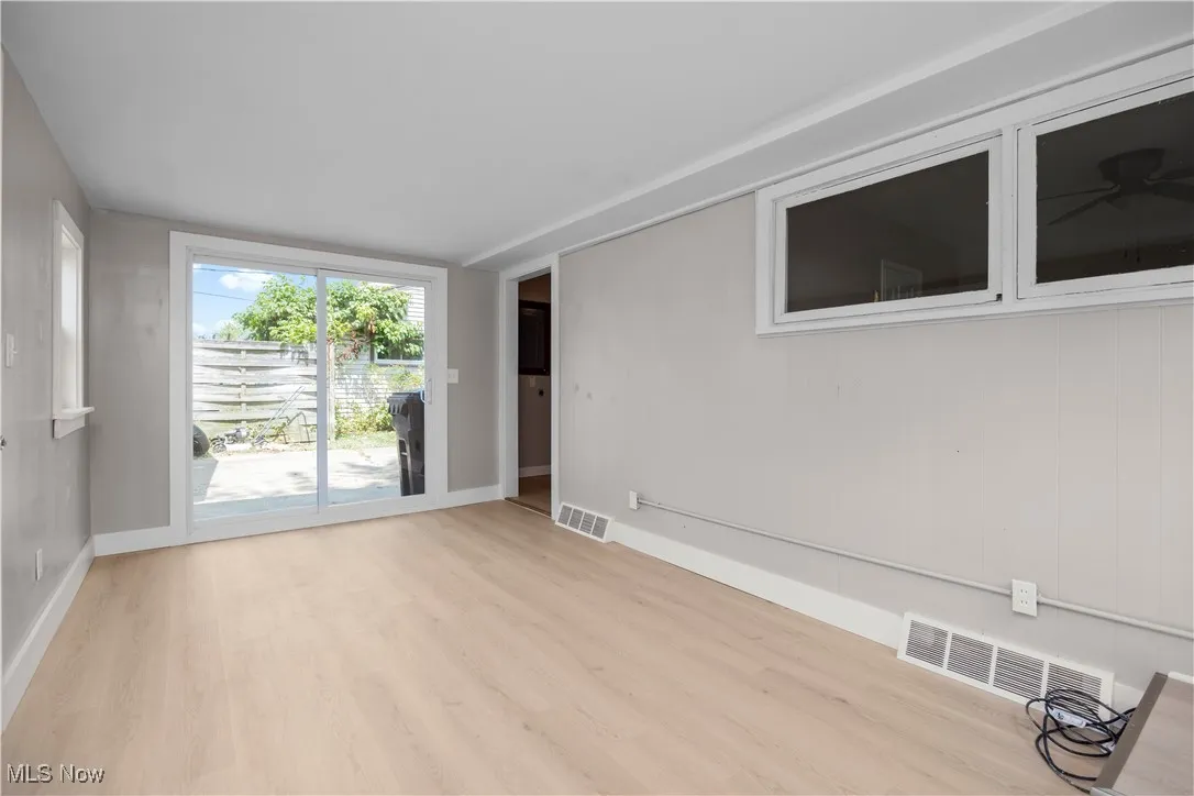 Empty room with wood finished floors and baseboards