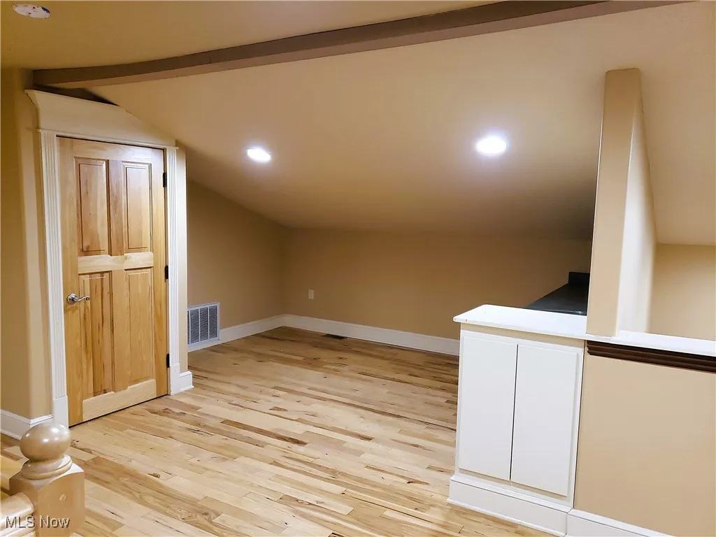 Additional living space featuring light wood-type flooring, recessed lighting, and vaulted ceiling