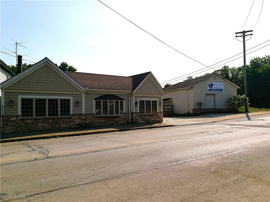 View of front facade featuring stone siding