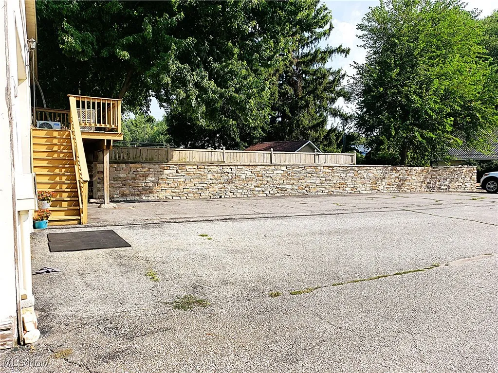 View of yard with stairway, a patio area, and a wooden deck