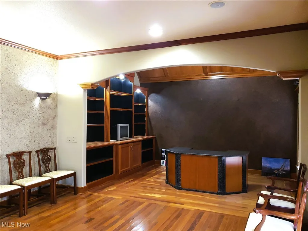 Office space featuring ornamental molding and light wood finished floors
