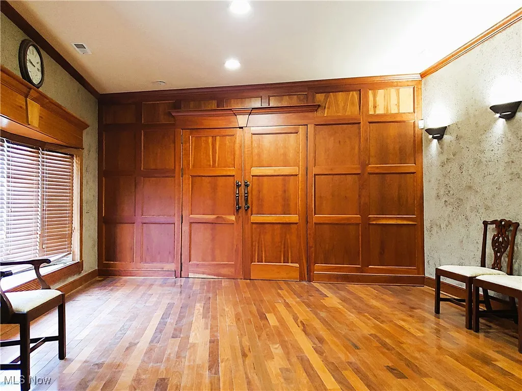 Foyer with light wood-style floors, crown molding, and recessed lighting