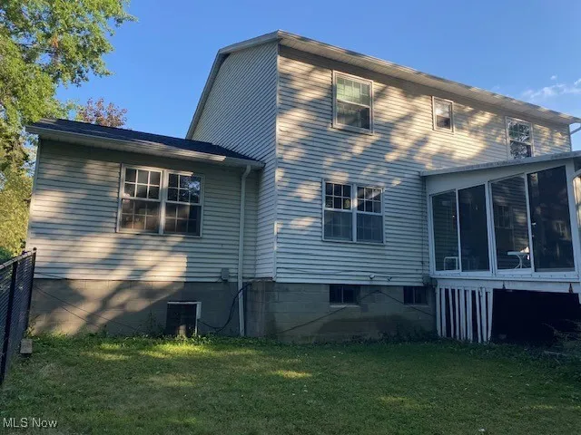 Rear view of house with a sunroom
