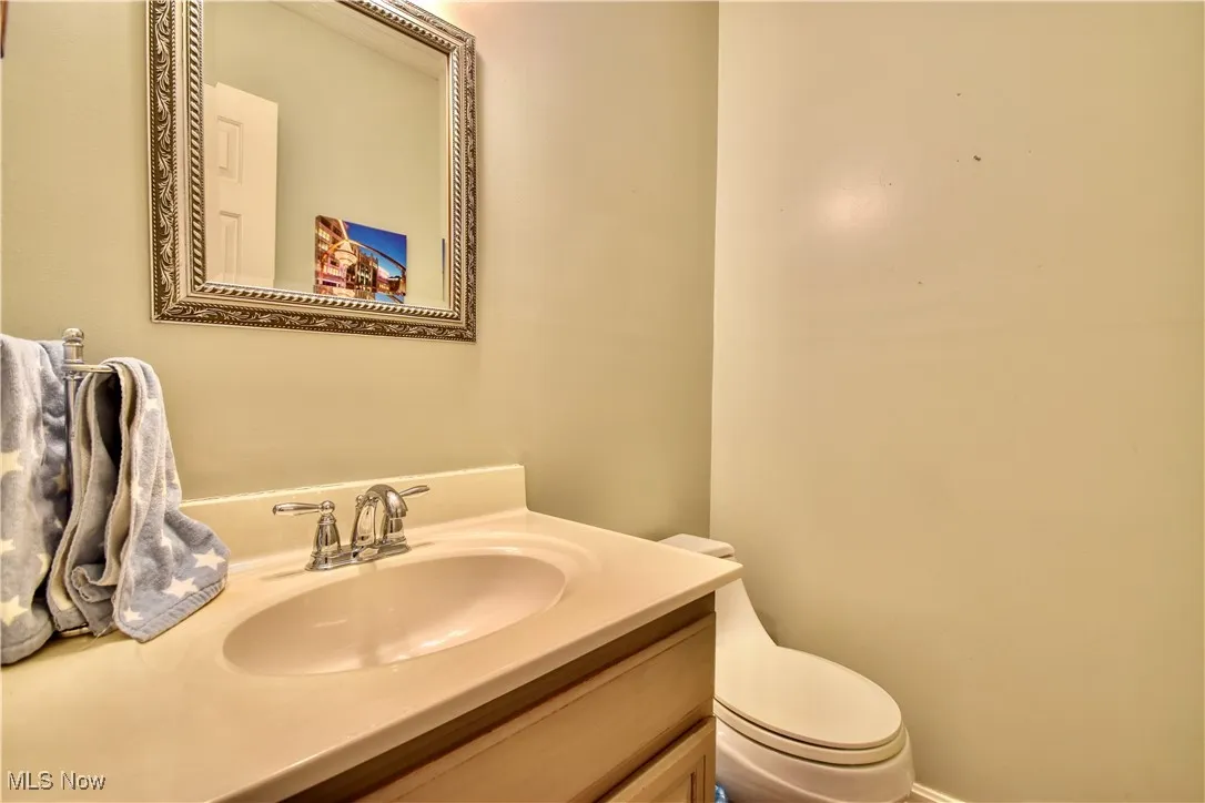 Half bath featuring vanity and toilet