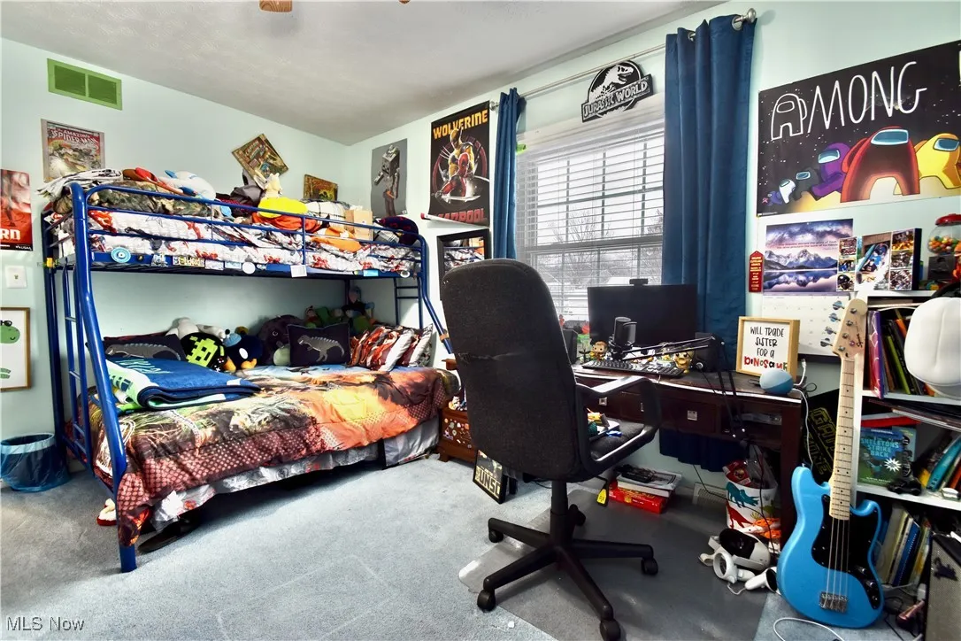 Bedroom featuring carpet, a desk, and ceiling fan