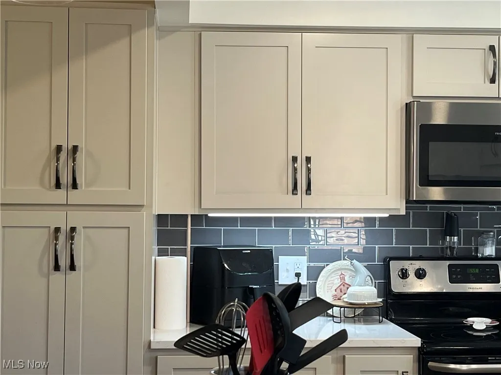 Kraftmaid white cabinets with modern hardware.