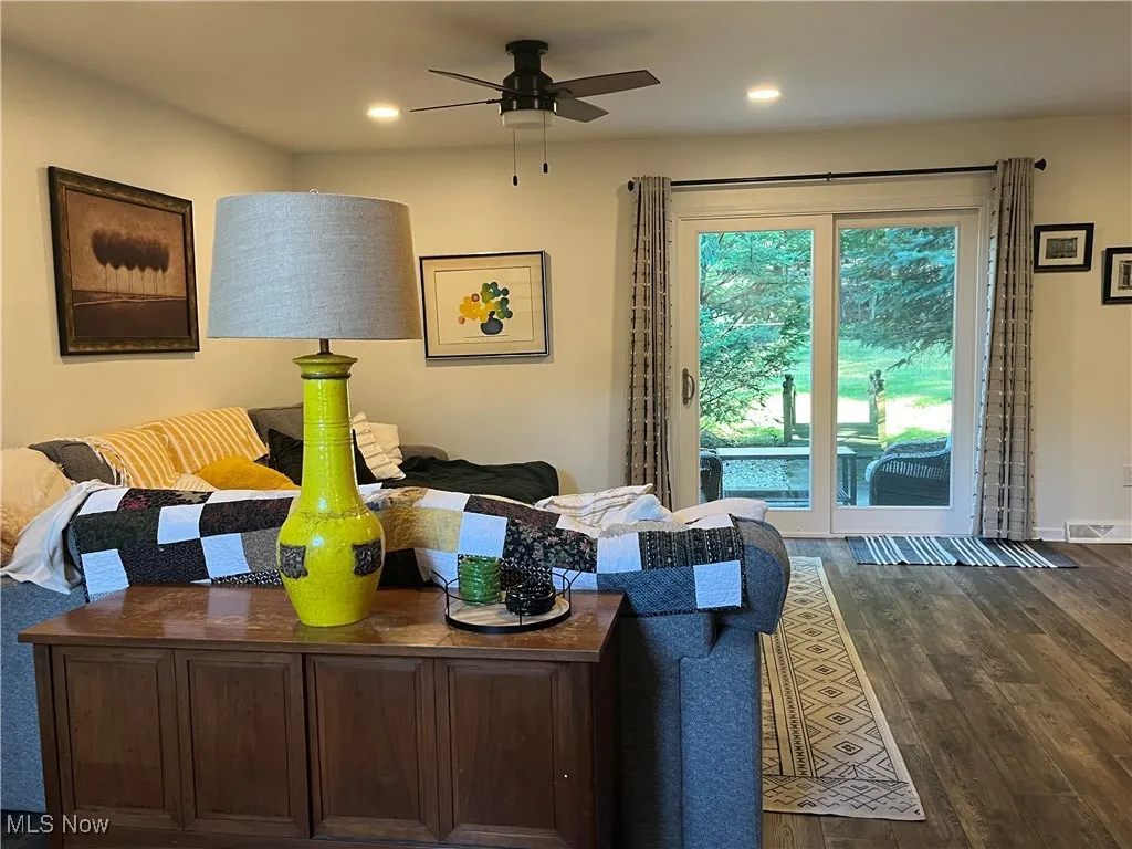 Living room featuring dark wood-style floors, recessed lighting, and a ceiling fan