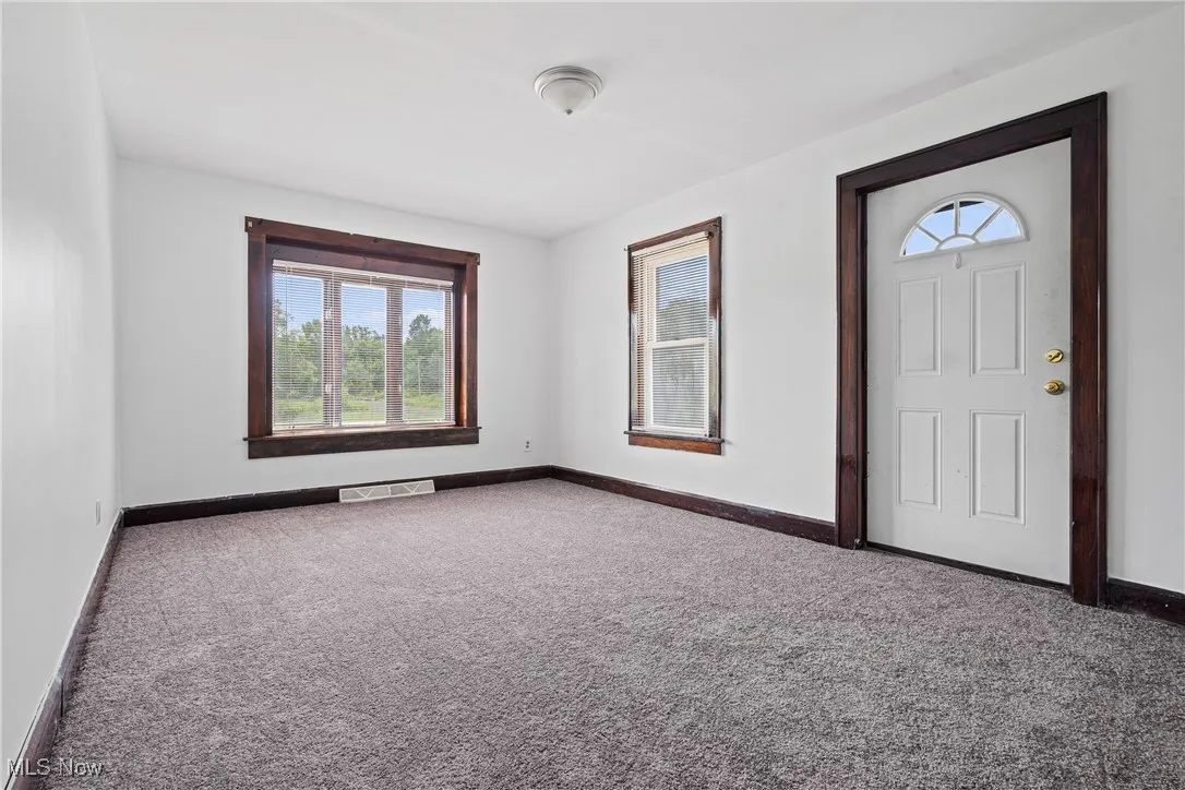 Foyer entrance with healthy amount of natural light and carpet flooring