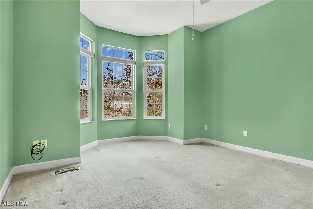 Spare room featuring baseboards and carpet flooring