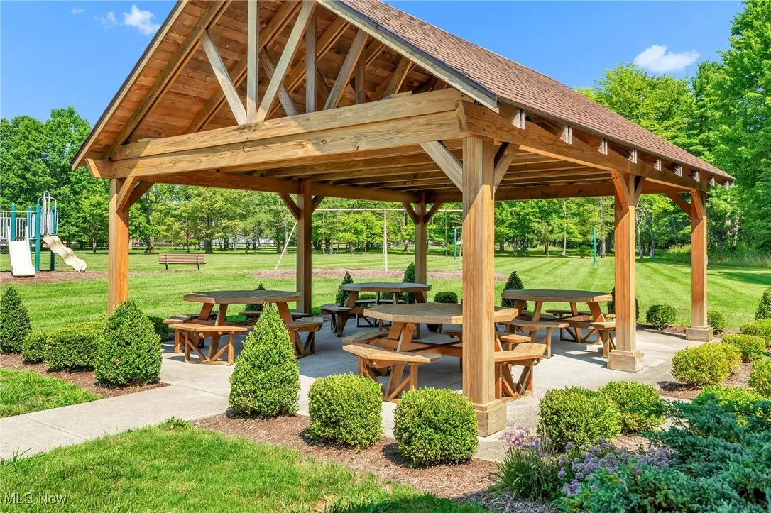 View of property's community featuring a patio and a yard