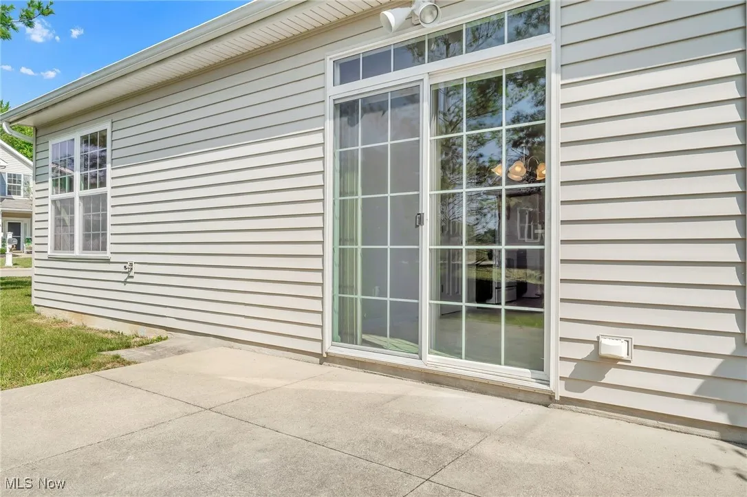 View of side of home featuring a patio area